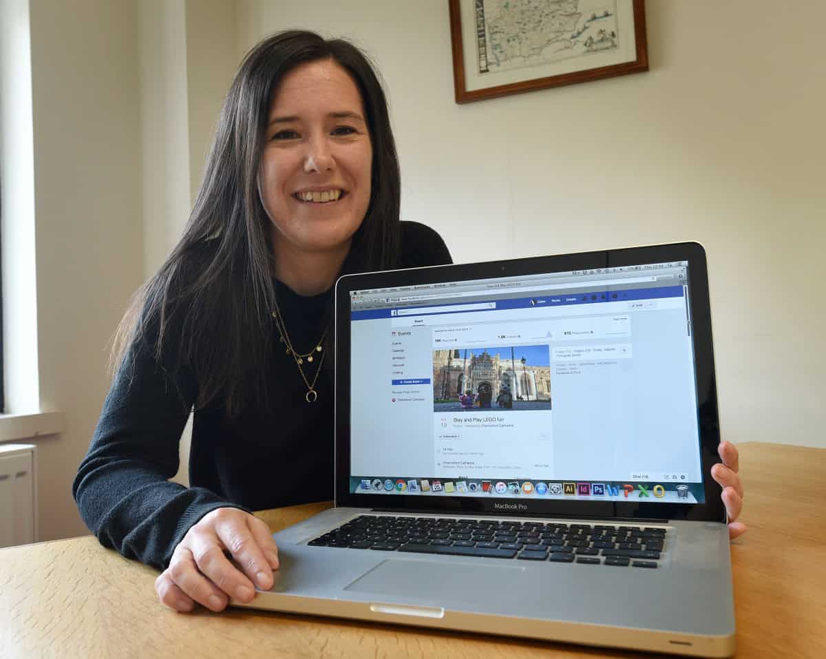 Woman sitting next to an open laptop