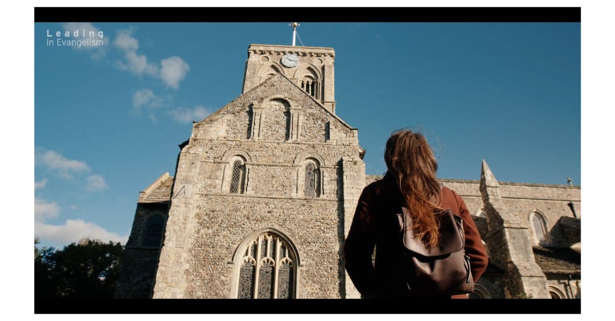 Person looking up at church building
