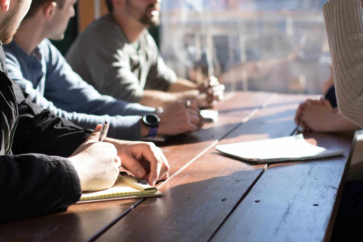 People at a meeting taking notes