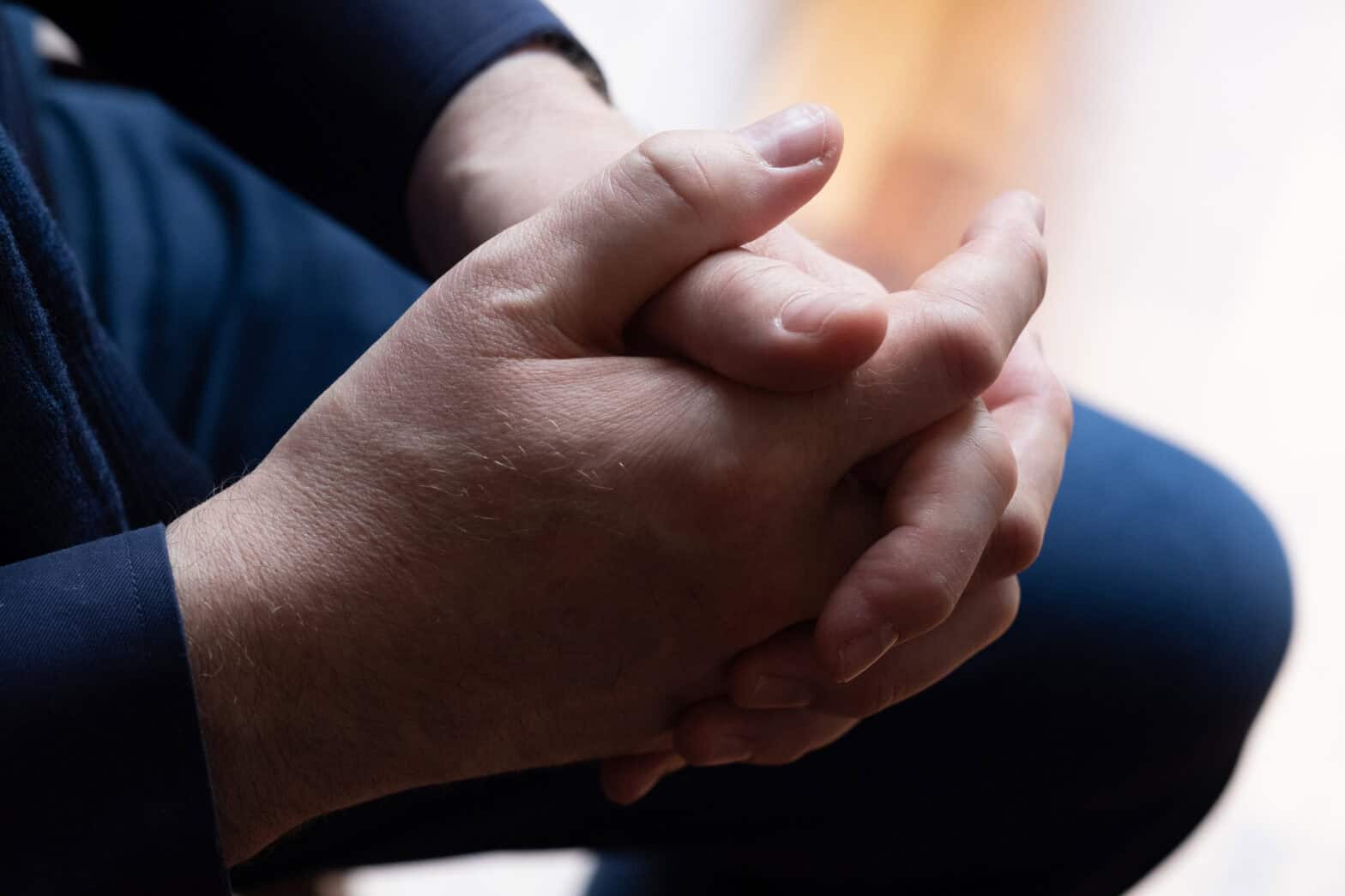 Close up of clasped hands