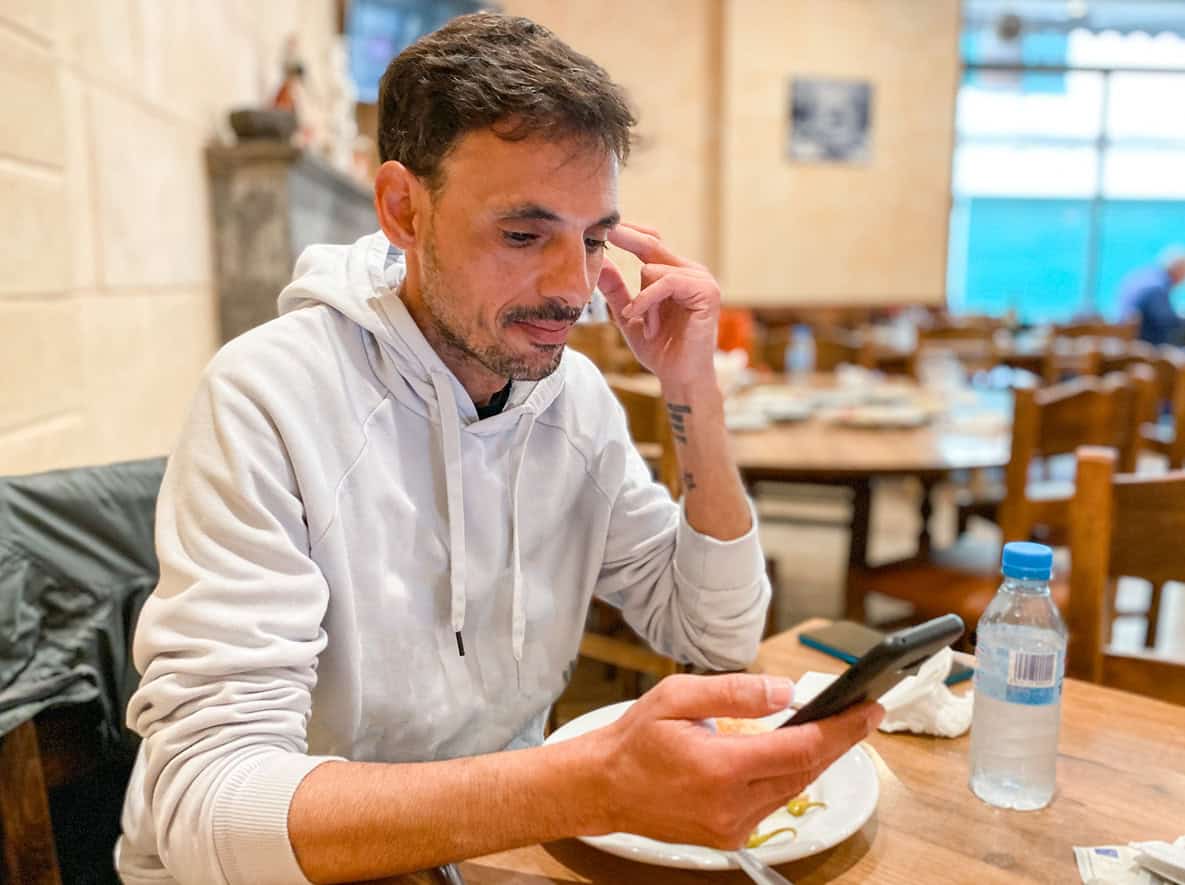 Man sitting in a cafe on his phone
