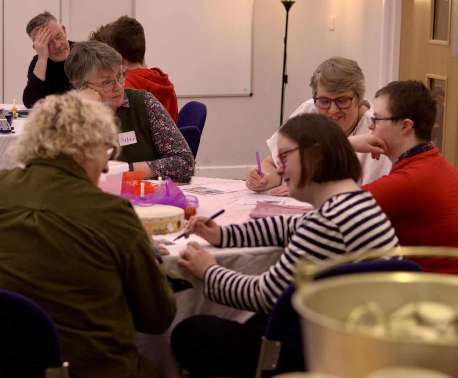 Group of people sitting around a round table and having a conversation