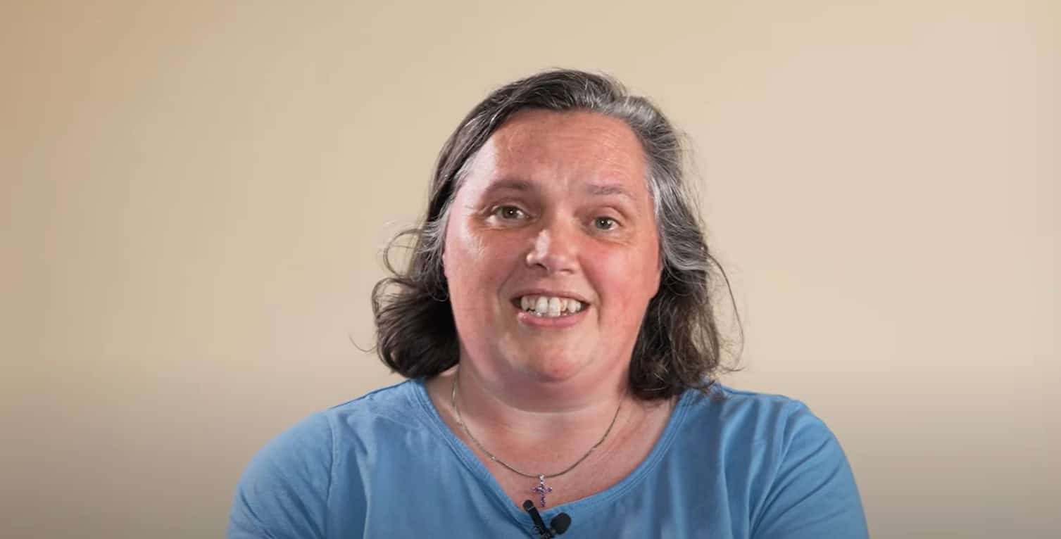 Smiling woman speaking to camera