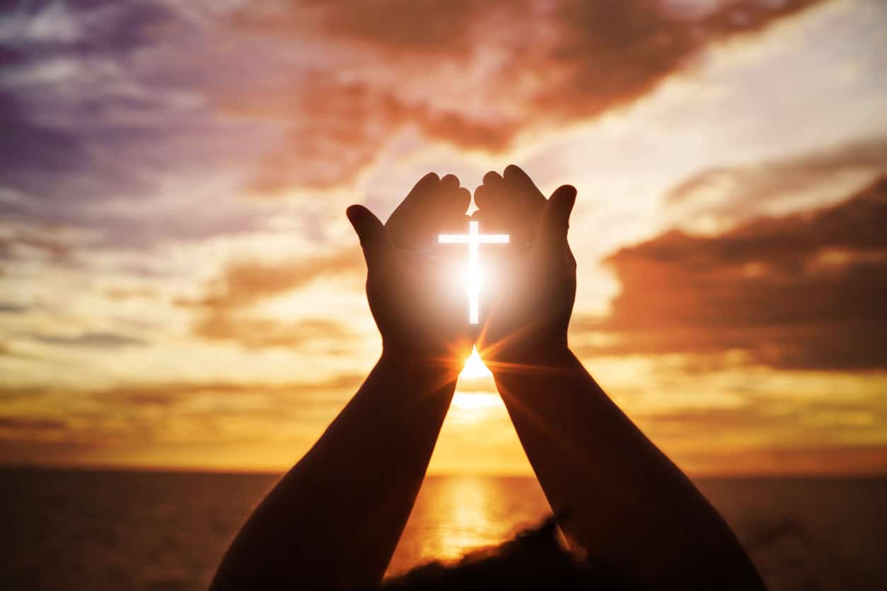 Hands open palm up worship with the sky in the background