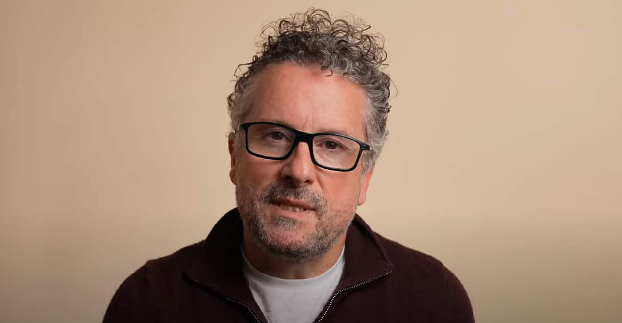 Man with glasses speaking