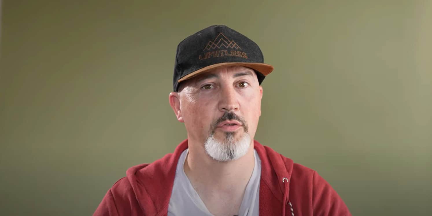 Man wearing baseball cap on olive background