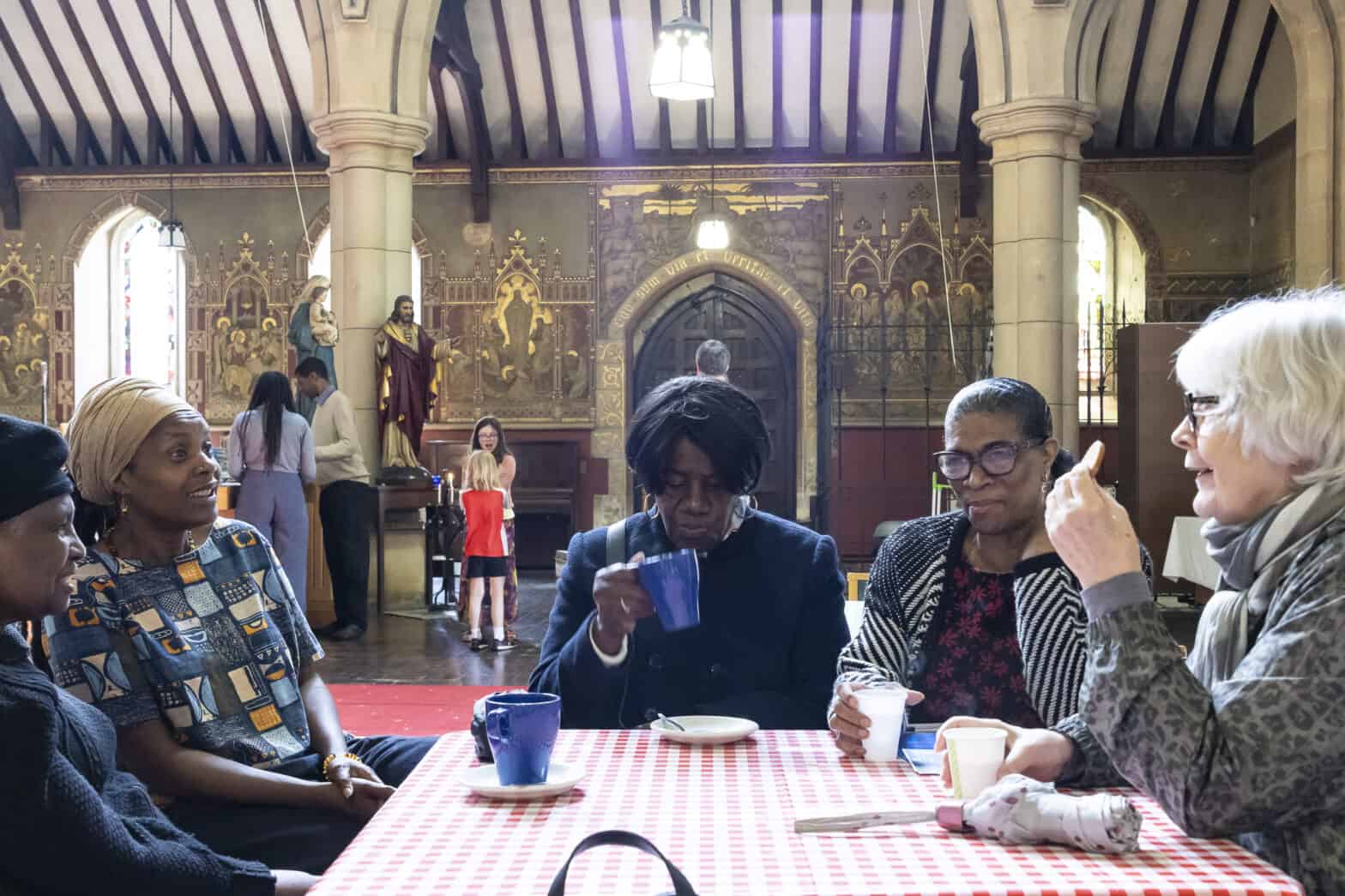 Women sitting around a table in a church having a conversation
