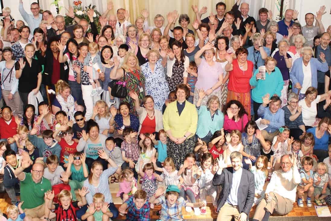 Image of lots of people at a church who look like they're enjoying themselves