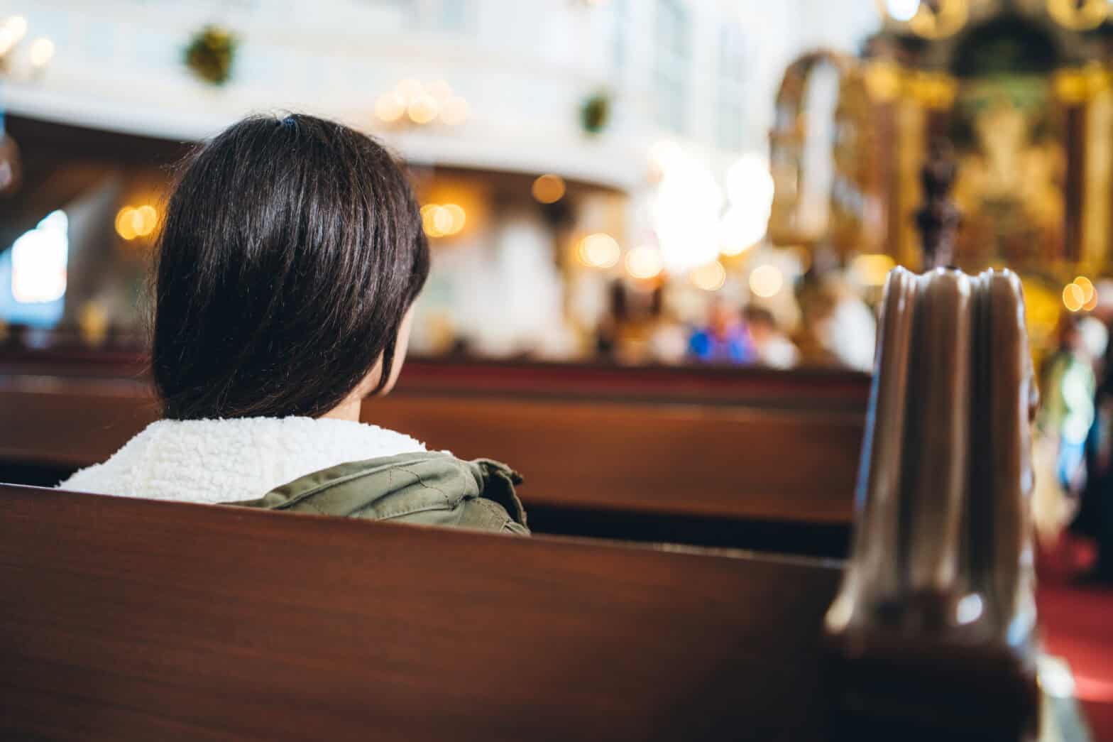 A woman sitting in a Church attending a service