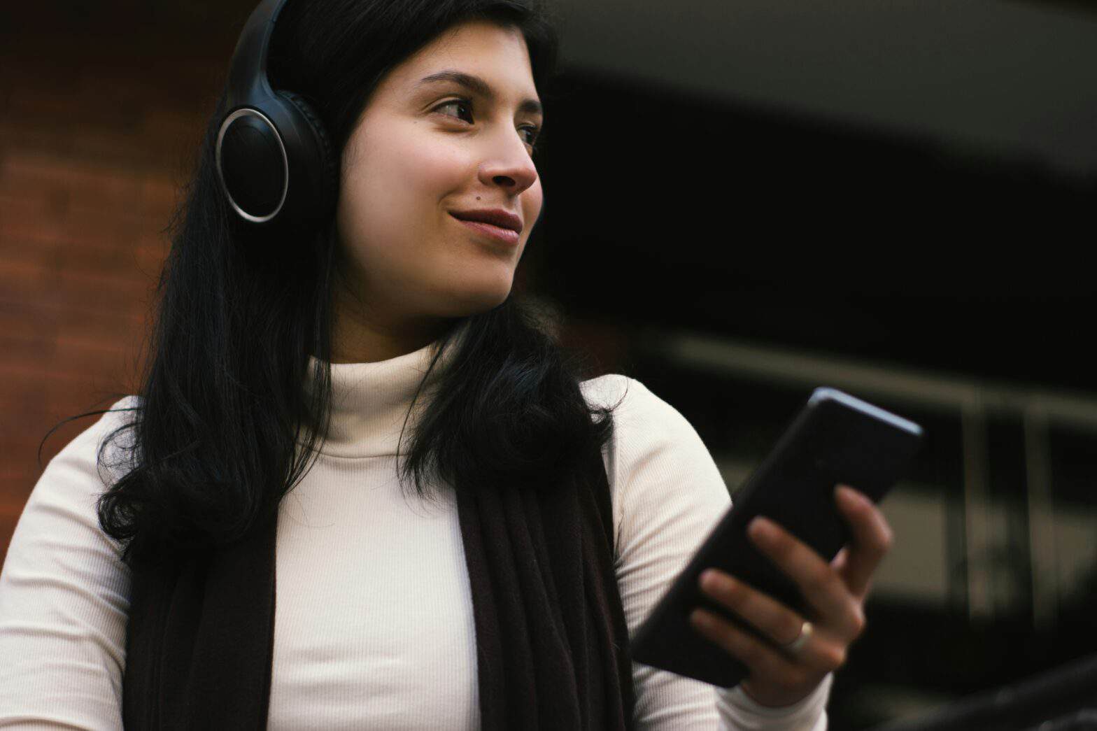 Young lady listening to podcast on a SmartPhone