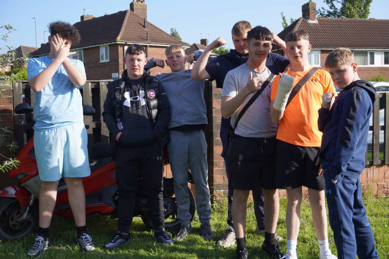 Group of teenage boys who are friends, part of an MYCN group, posing for a picture while being silly and having fun
