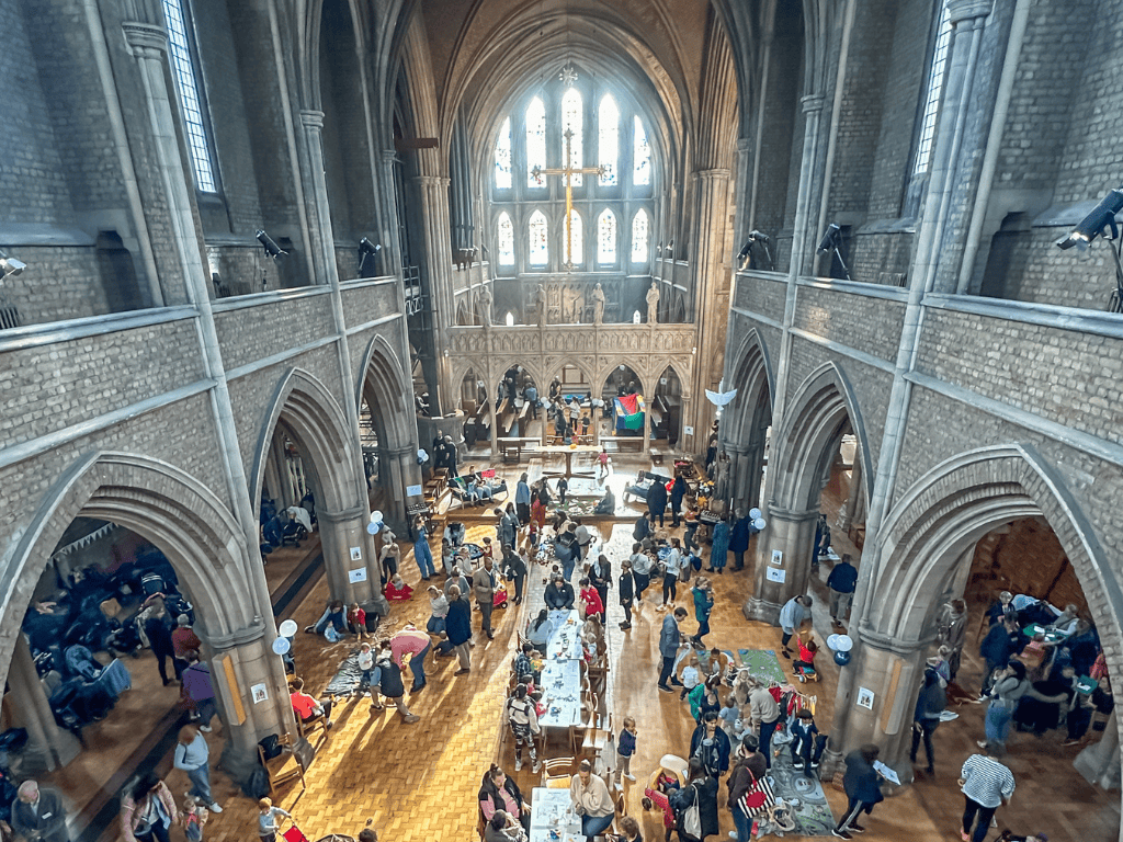 A busy church full of several people taking part in different activities