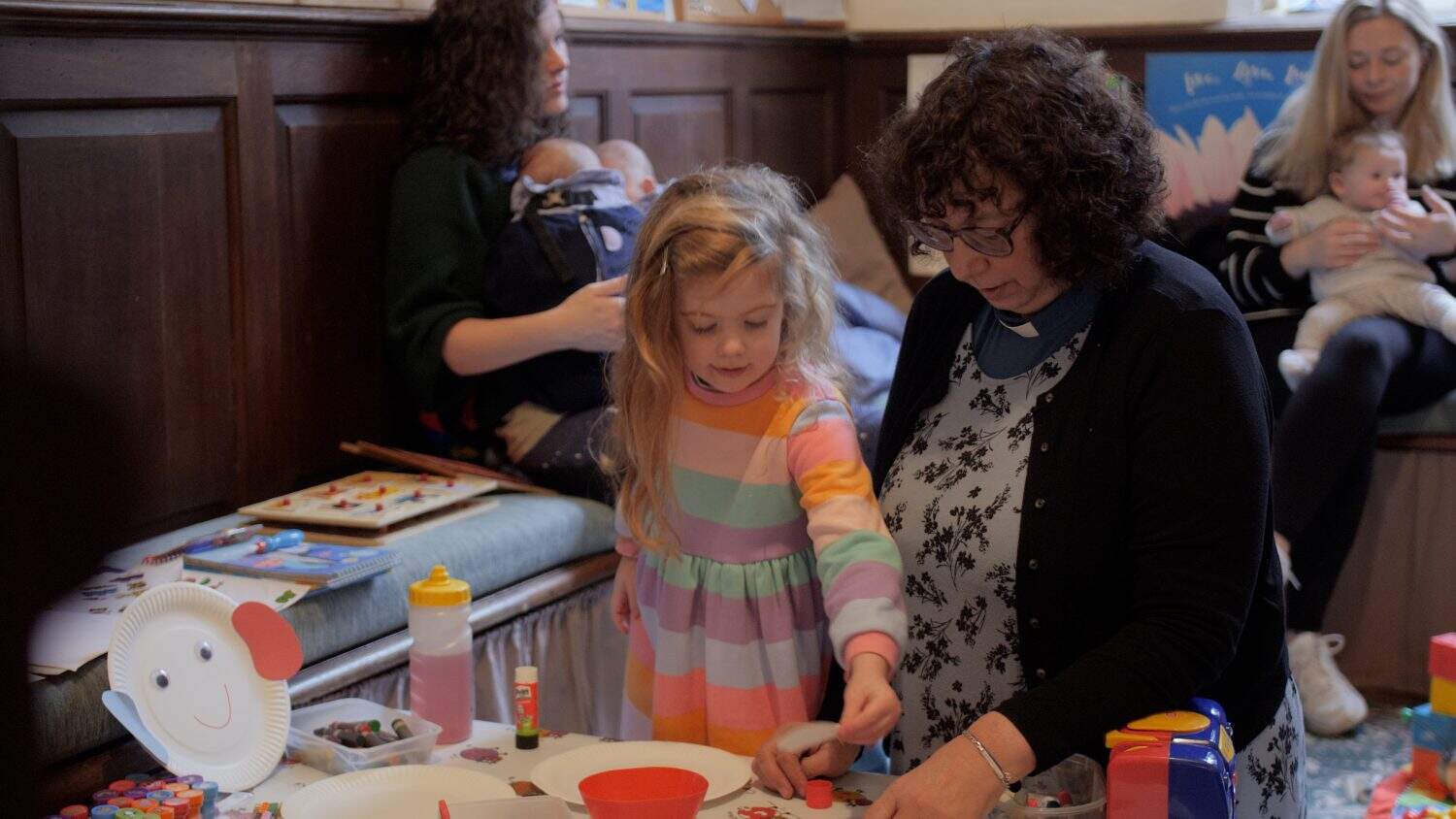 Mother and child doing a craft together in a church
