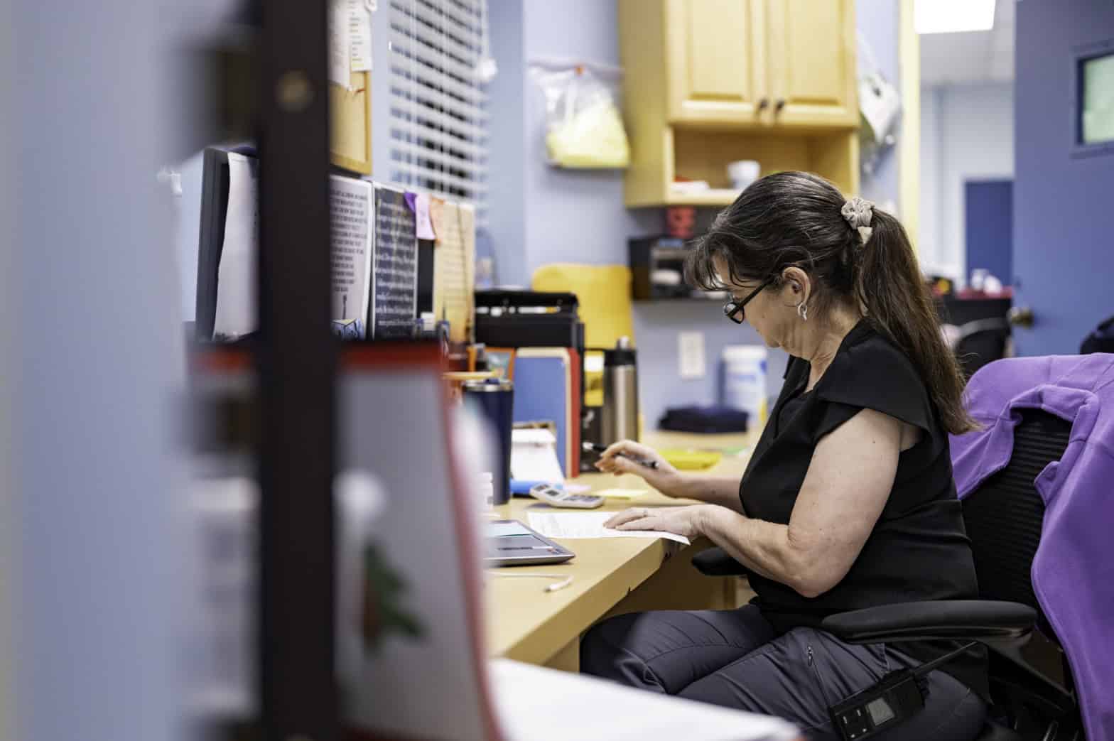 Woman working at a desk with papers