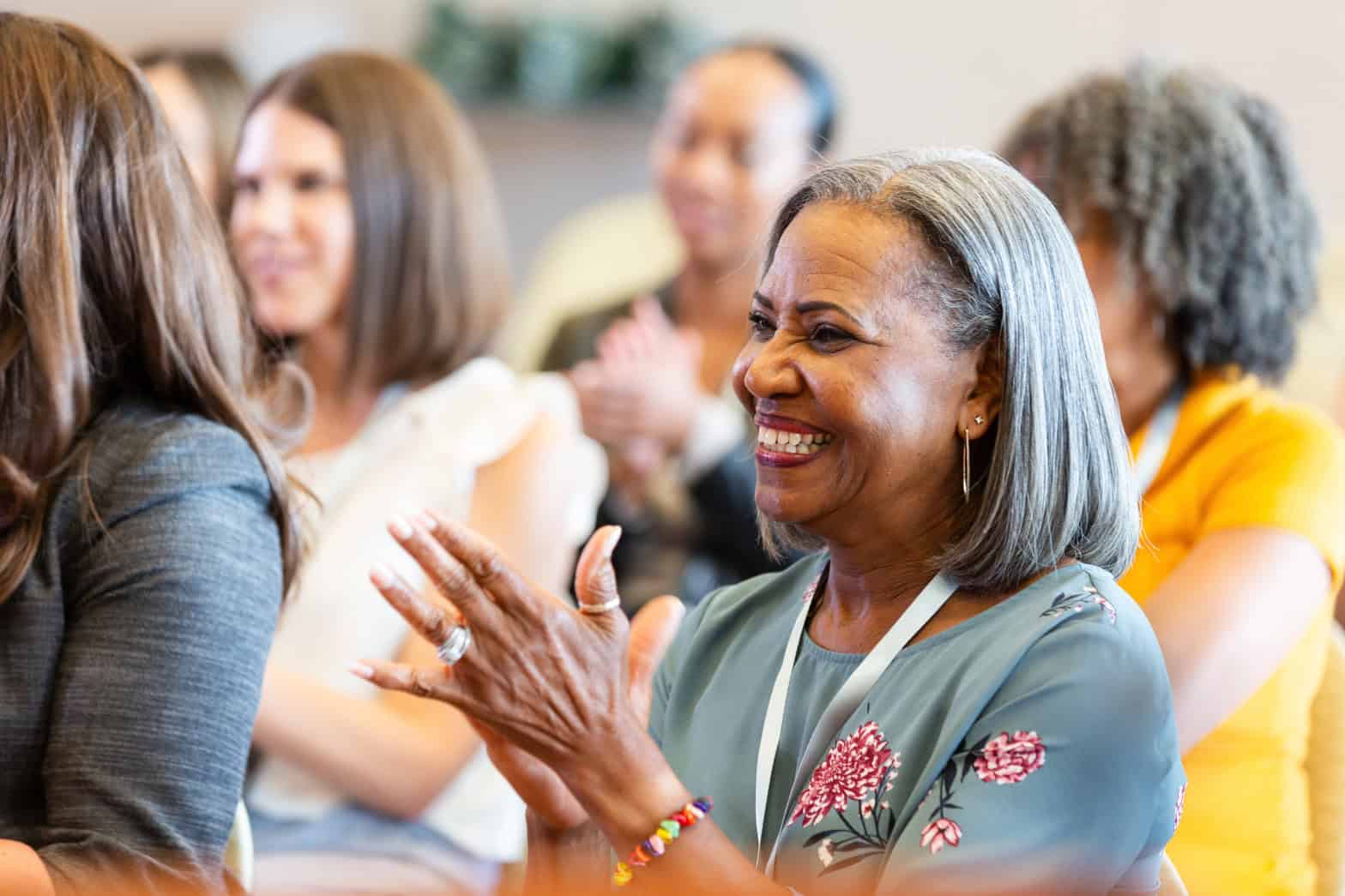 A group of women smiling and looking happy and engaged